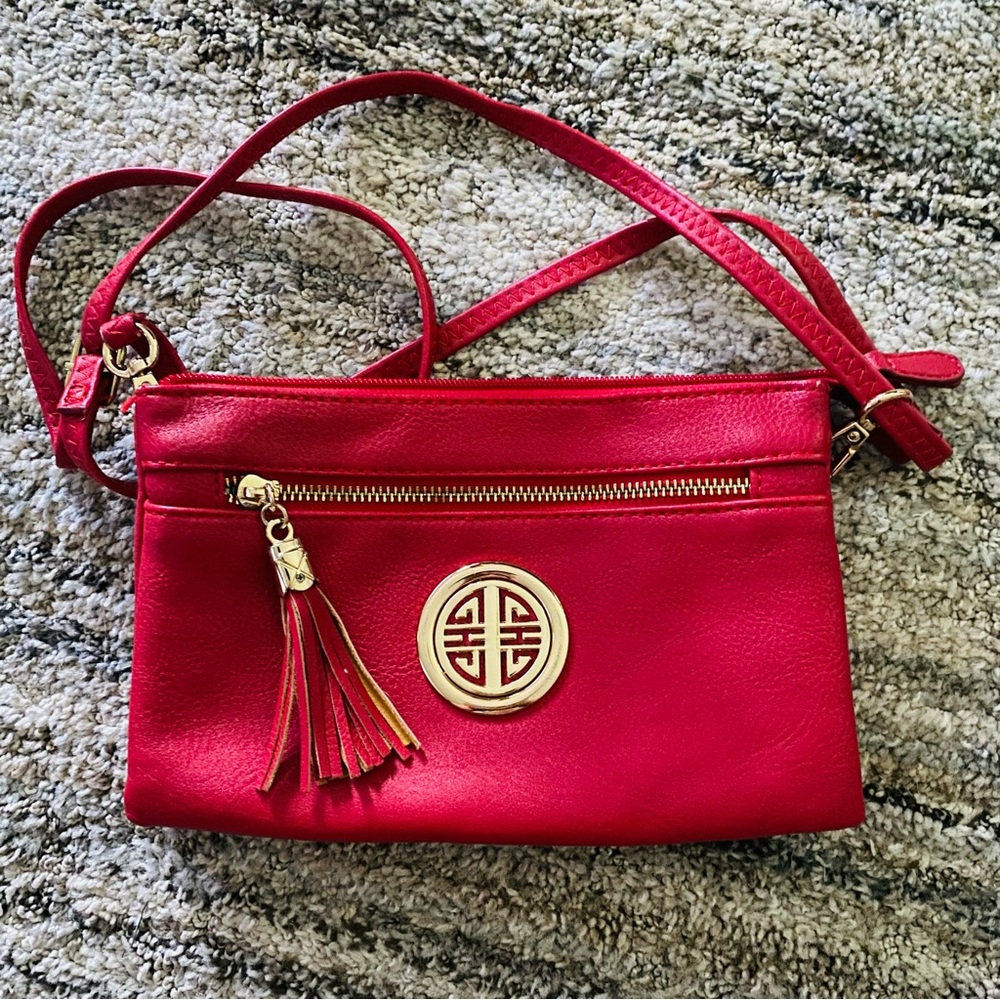 Red Crossbody Bag with Gold Emblem and Tassel